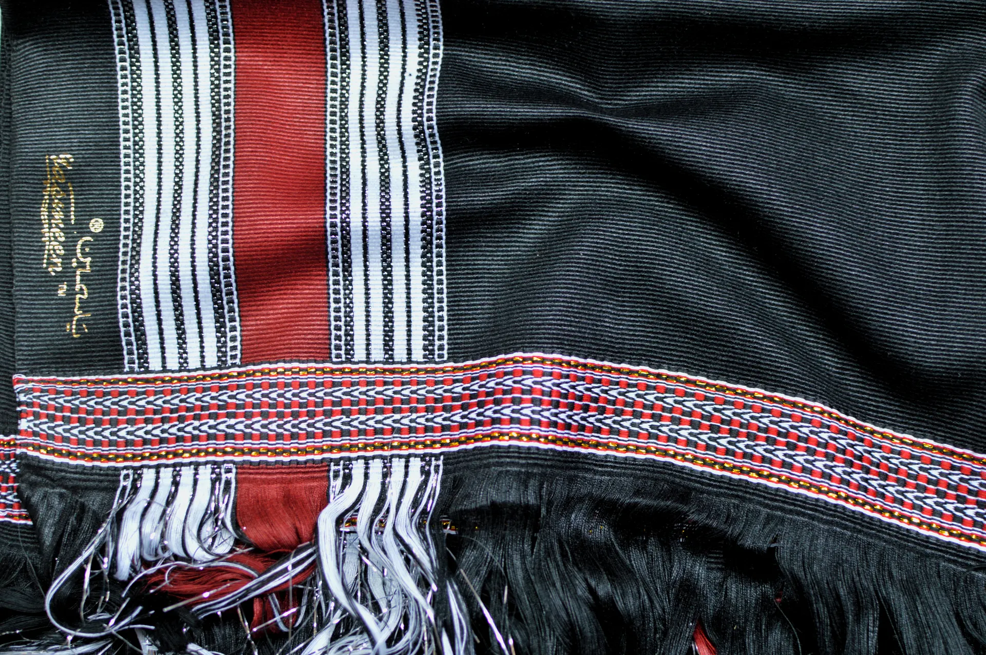 Black sarong with red and white woven border detail